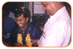 Mr. N Bitra Receiving A memento from Pinnamaneni Venkateswara Rao, Minister Technical Education, on the occasion of 56th Independence Day (15th August 2003). Bitra Net Pvt. Ltd., has donated two letest configuration computers to a School located in Puttagunta (Krishna Dist, Andhra Pradesh)